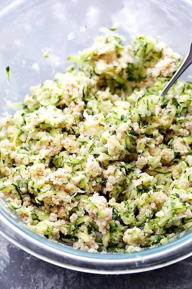 Shredded Zucchini mixture in a bowl being prepared for making zucchini meatballs.