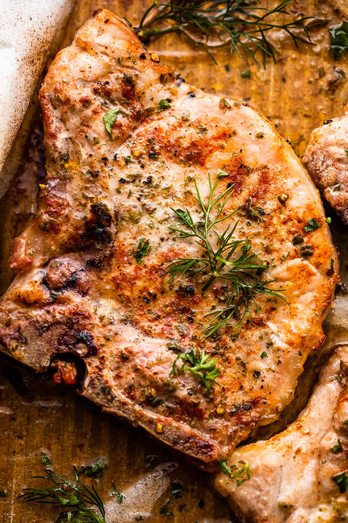 close up photo of one pork chop seasoned with ranch seasoning mix