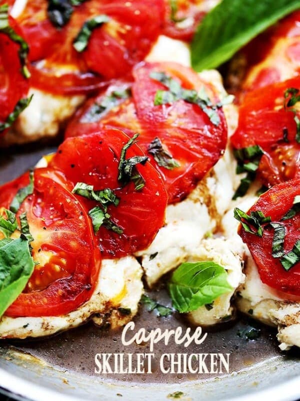 Caprese Skillet Chicken Recipe - Pan-seared chicken topped with melting mozzarella cheese, fresh tomatoes, a sprinkle of basil, and a drizzle of balsamic vinegar. Quick, easy, and SO delicious!