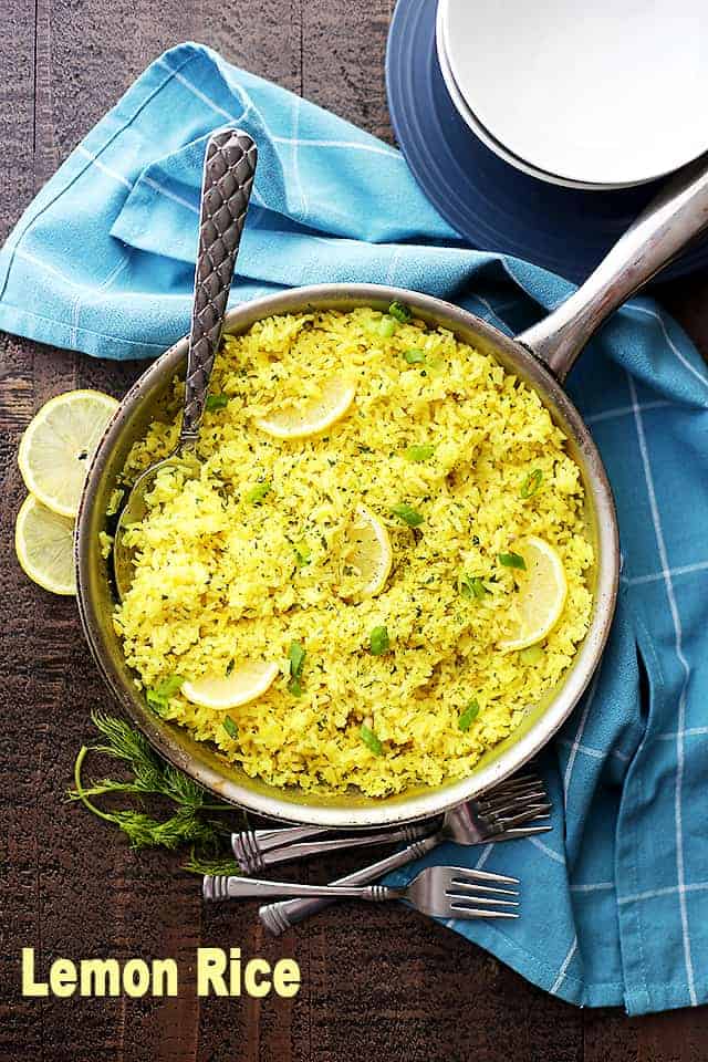 Lemon Rice served in a skillet, with a spoon mixing through it.