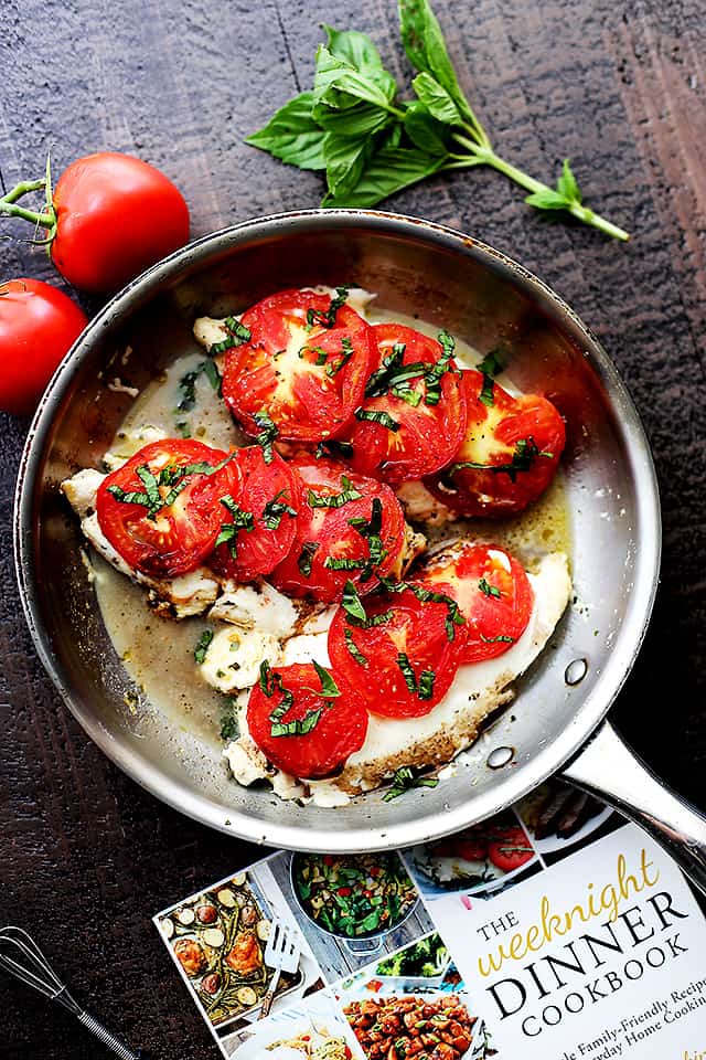 Caprese Skillet Chicken Recipe - Pan-seared chicken topped with melting mozzarella cheese, fresh tomatoes, a sprinkle of basil, and a drizzle of balsamic vinegar. Quick, easy, and SO delicious!