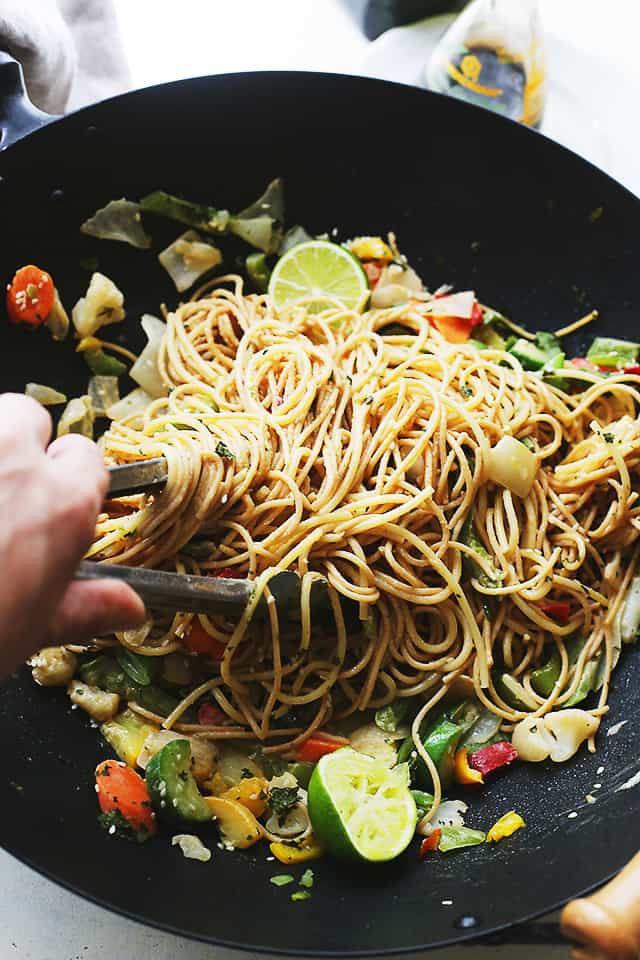 Garlic Peanut Noodles Recipe - Delicious noodles and stir fried vegetables are tossed in garlic olive oil and coated in a mixture of peanut butter, soy sauce, lime juice, hot sauce and ginger. 