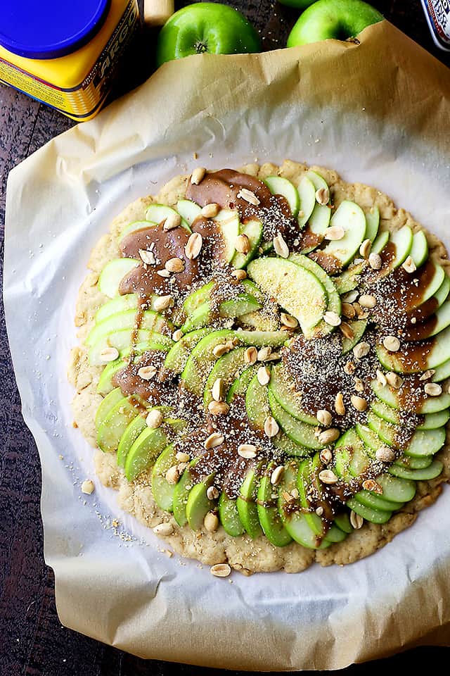 Gluten Free Caramel Apple Pizza with Streusel Topping - A delicious dessert pizza featuring a gluten free pizza crust, apples, a drizzle of caramel, and a sweet and crumbly streusel topping.