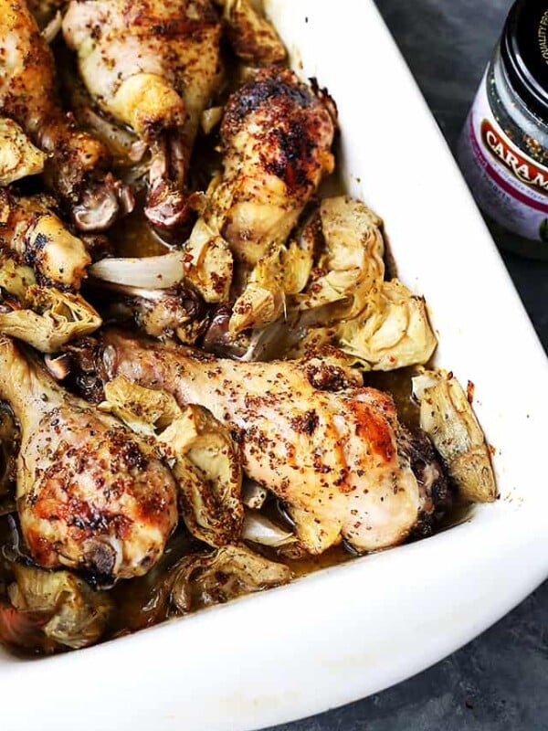 Overhead shot of a baking dish with baked chicken and artichokes.