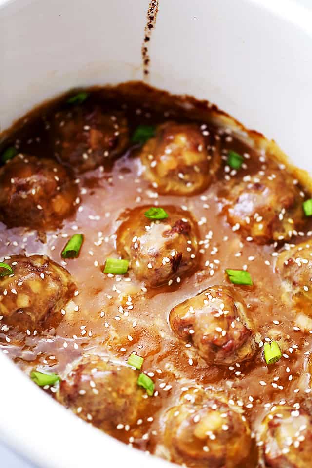 Crock Pot Asian Meatballs - Tender and juicy meatballs slow cooked in an amazing sweet and tangy pineapple-soy sauce. These are perfect for dinner, game days, or any and all celebrations!