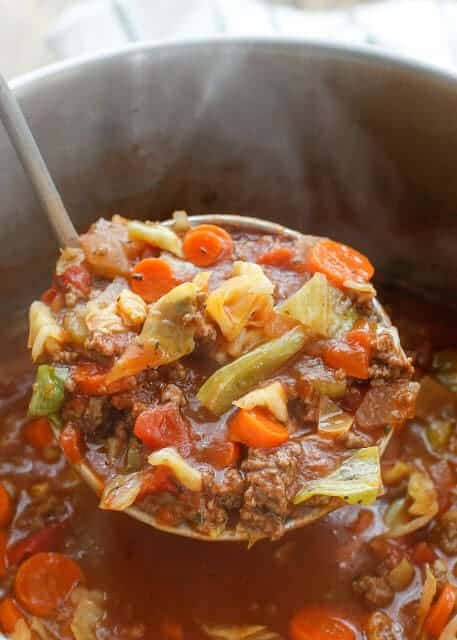 A ladle full of Hearty Italian Vegetable Beef Soup in a pot