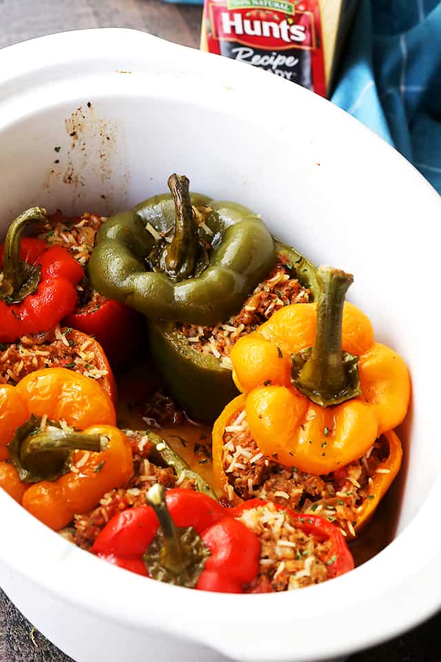 Crock Pot Stuffed Peppers arranged inside the insert of a slow cooker.