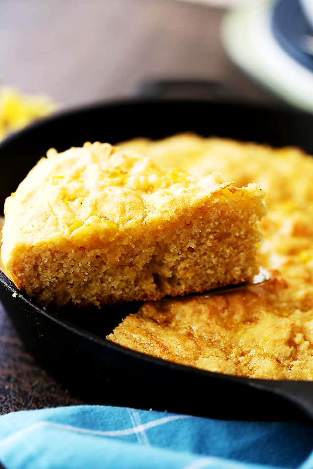 Healthy cornbread filled with sweet corn and cheese is served straight from a cast iron skillet