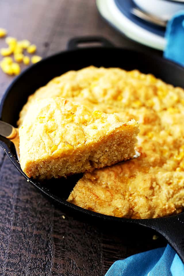 Cornbread being served from a skillet.