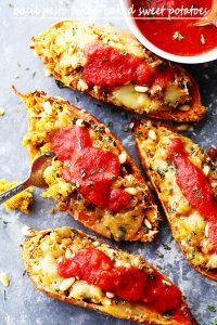 Basil Pesto Twice-Baked Sweet Potatoes - Twice baked, savory sweet potatoes stuffed with a delicious basil pesto mixture, and topped with melty mozzarella cheese and marinara!