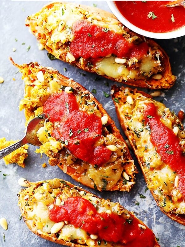 Basil Pesto Twice-Baked Sweet Potatoes - Twice baked, savory sweet potatoes stuffed with a delicious basil pesto mixture, and topped with melty mozzarella cheese and marinara!