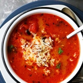 A Large Bowl of Taco Soup Garnished with Shredded Mozzarella Cheese on a Countertop