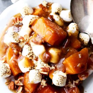 Sweet potato casserole with marshmallows served on a plate.