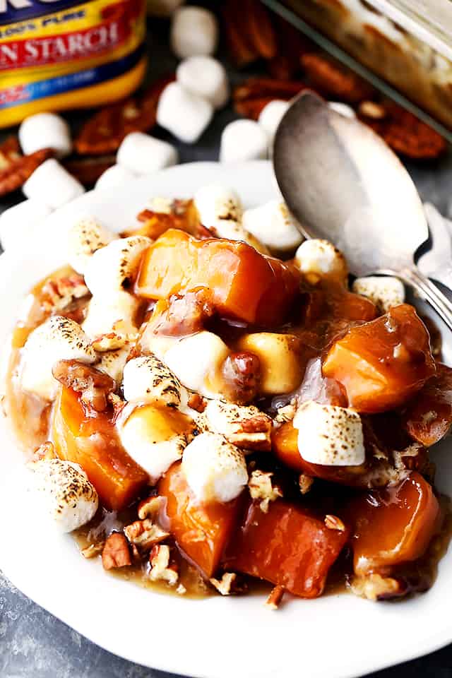 Sweet potato chunks, marshmallow, and pecans served on a plate.