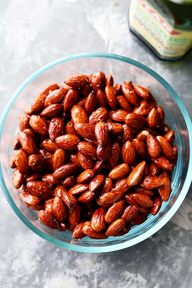 Honey roasted almonds in a glass serving bowl.