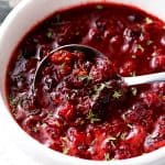 Slow Cooker Cranberry sauce in a serving dish with a spoon.