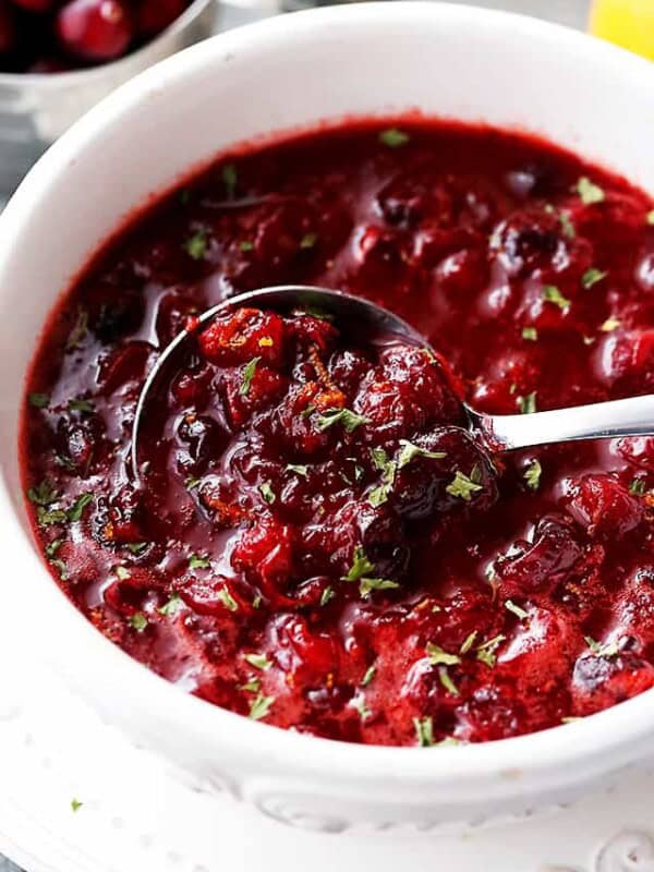 Slow Cooker Cranberry sauce in a serving dish with a spoon.