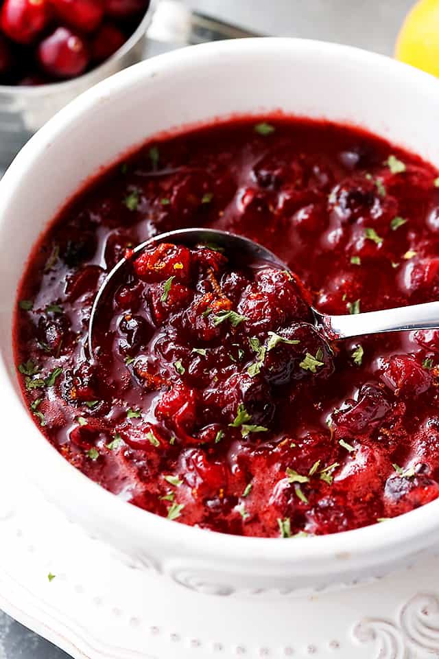 Slow Cooker Cranberry sauce in a serving dish with a spoon.