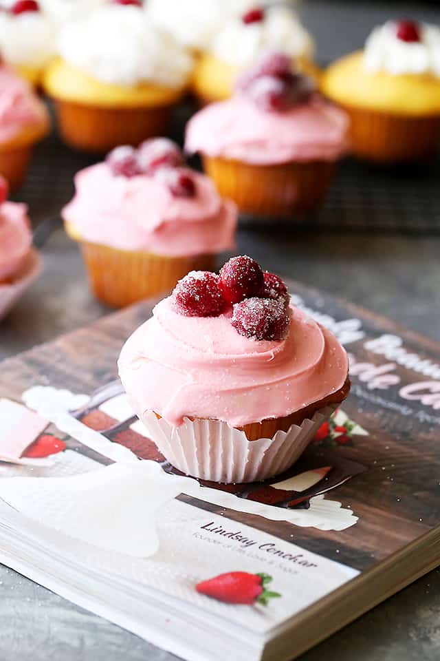Sparkling Cranberry White Chocolate Cupcakes - Perfectly moist cupcakes filled with a creamy white chocolate ganache, and topped with a fresh cranberry frosting and sugared cranberries! 