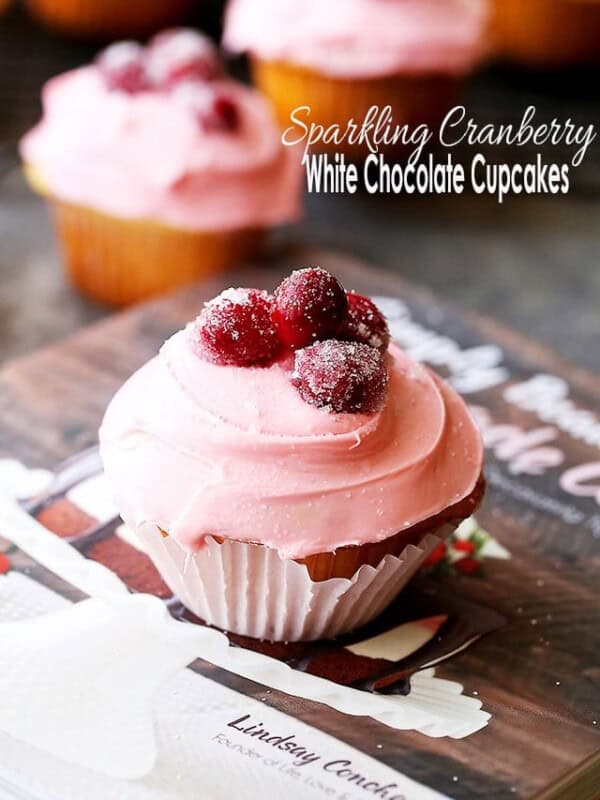 Sparkling Cranberry White Chocolate Cupcakes - Perfectly moist cupcakes filled with a creamy white chocolate ganache, and topped with a fresh cranberry frosting and sugared cranberries!