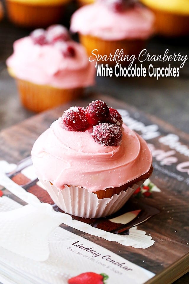 Sparkling Cranberry White Chocolate Cupcakes - Perfectly moist cupcakes filled with a creamy white chocolate ganache, and topped with a fresh cranberry frosting and sugared cranberries! 