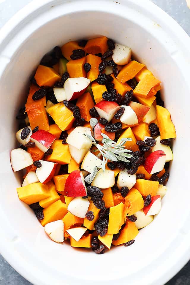 Crock Pot Butternut Squash with Apples, Walnuts and Raisins - This easy, delicious, and simple holiday side dish combines butternut squash, fresh apples, crunchy walnuts and sweet raisins cooked simply in the crock pot.