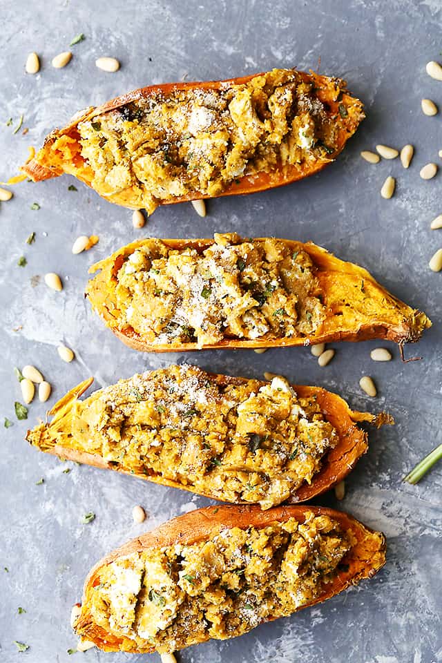 Basil Pesto Twice Baked Sweet Potatoes - Twice baked, savory sweet potatoes stuffed with a delicious basil pesto mixture, and topped with melty mozzarella cheese and marinara! 