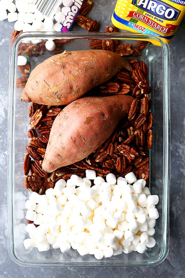 Orange and Pecans Sweet Potato Casserole - Delicious chunks of sweet potatoes baked in a luscious orange sauce, and topped with creamy marshmallows and crunchy pecans.