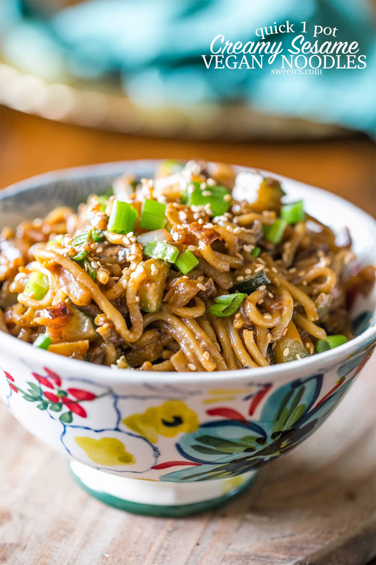 A bowl of vegan tahini noodles topped with scallions
