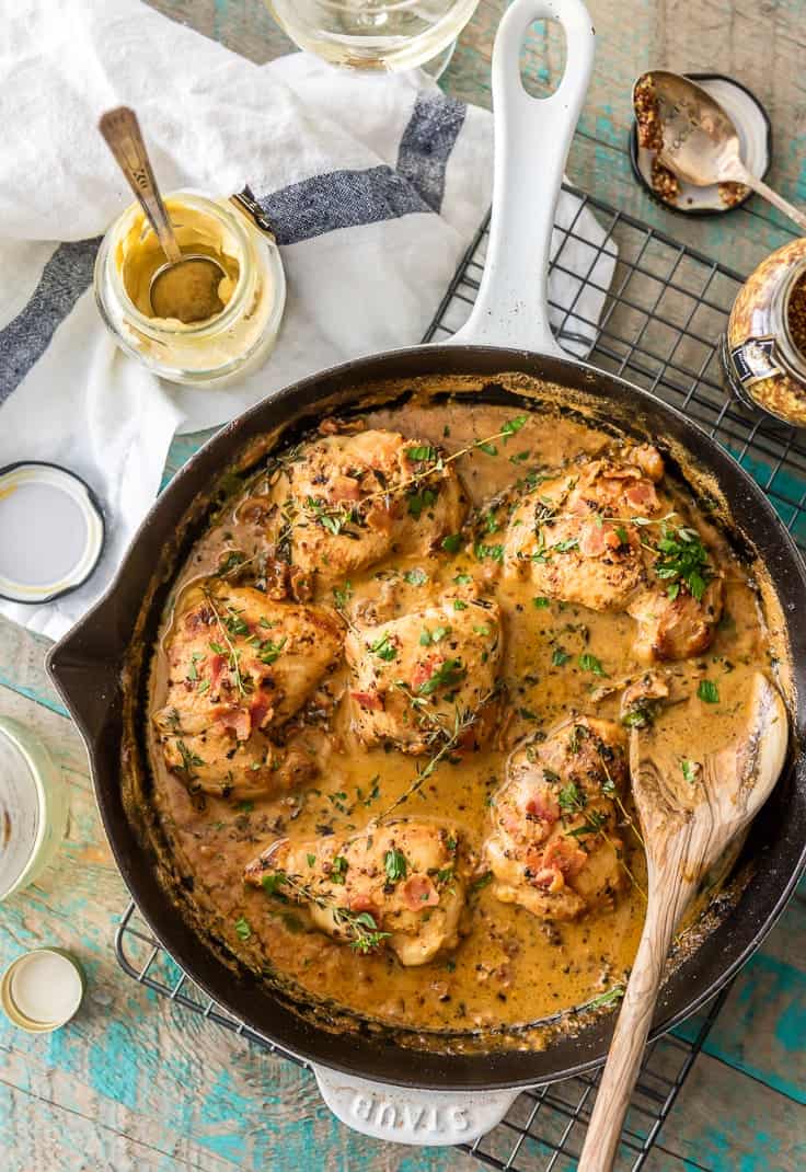 Top view of mustard chicken and bacon in a skillet