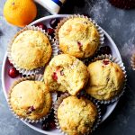 Overhead image of cornbread muffins served on a round plate.