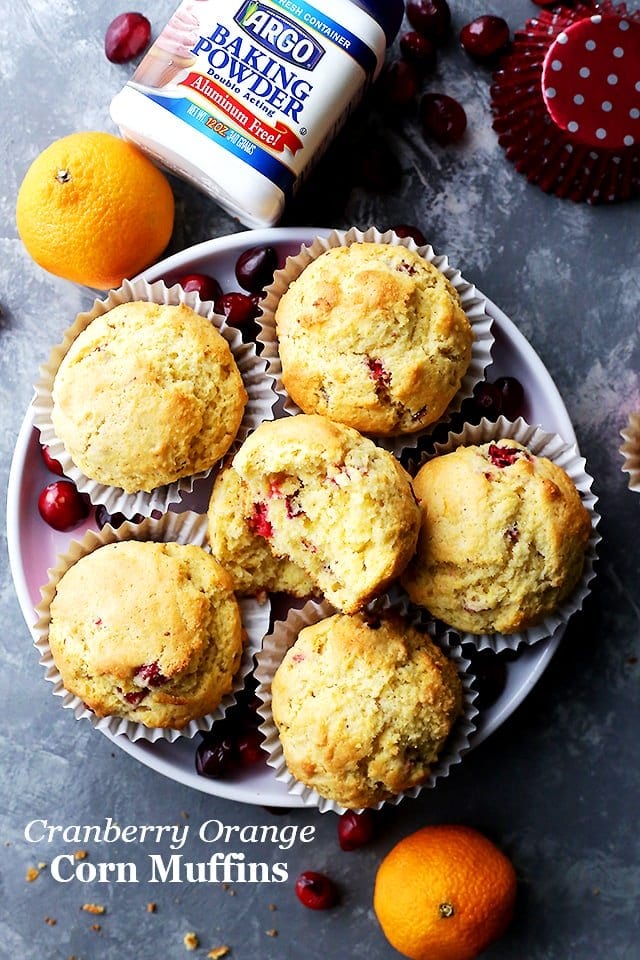 Overhead image of cornbread muffins served on a round plate.