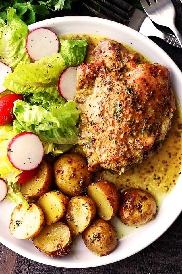 Chicken and Potatoes served on a white dinner plate.