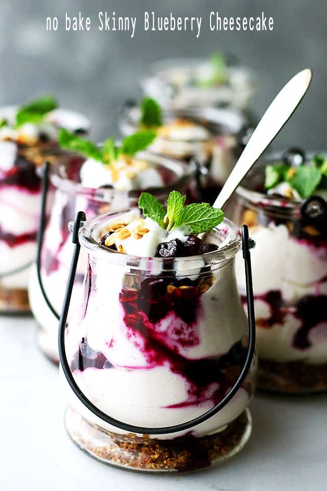 No Bake Skinny Blueberry Cheesecake Parfaits - Delicious layers of lightened-up creamy and lemony cheesecake filling, sweet granola, and a homemade blueberry sauce.