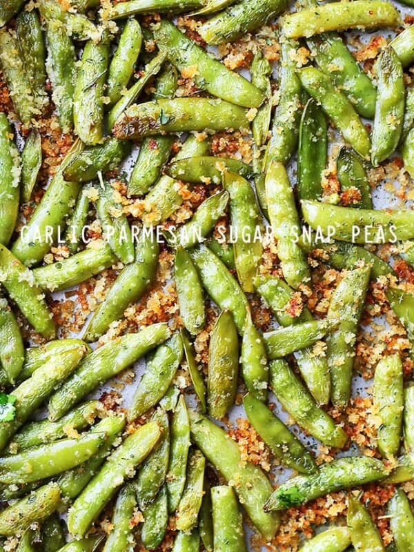 Garlic Parmesan Sugar Snap Peas arranged on a baking sheet.