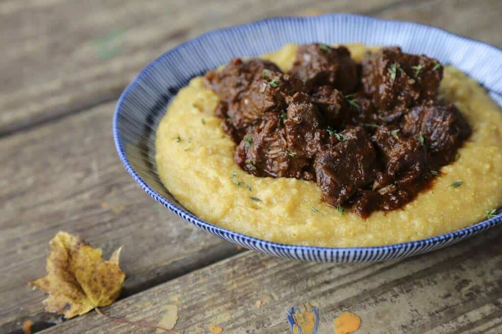Peposo Peppered Beef Stew over polenta in a bowl