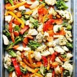 Overhead view of Asian-marinated chicken and veggies on a sheet pan.