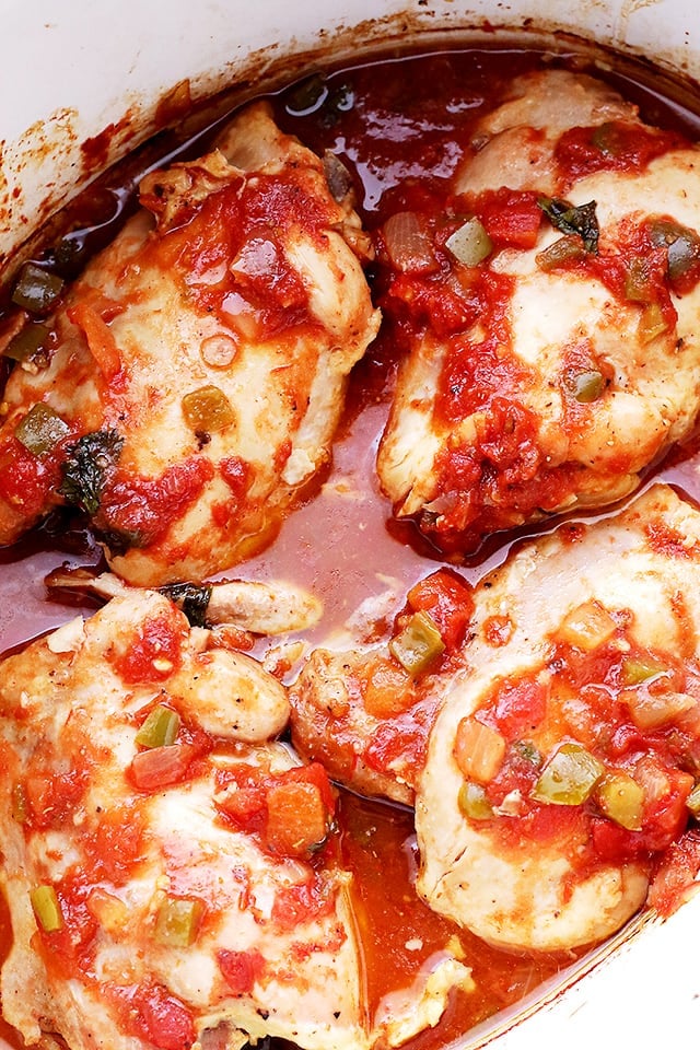 Four chicken breasts cooked in the slow cooker with tomatoes.