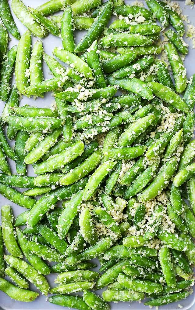 Garlic Parmesan Sugar Snap Peas - Healthy, delicious and quick to make roasted sugar snap peas tossed in a crunchy and flavorful parmesan cheese mixture.