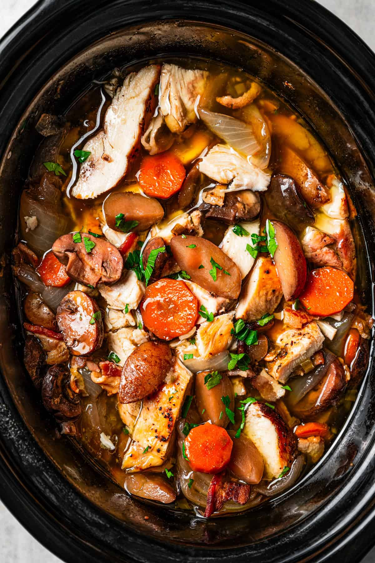 Coq au vin inside the slow cooker.