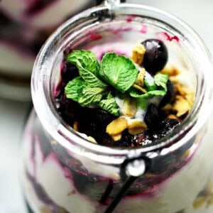No Bake Skinny Blueberry Cheesecake Parfaits - Delicious layers of lightened-up creamy and lemony cheesecake filling, sweet granola, and a homemade blueberry sauce.