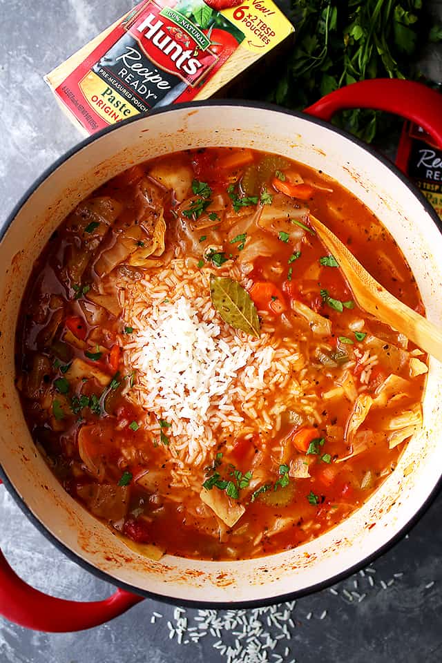 Stirring cooked rice into cabbage soup.