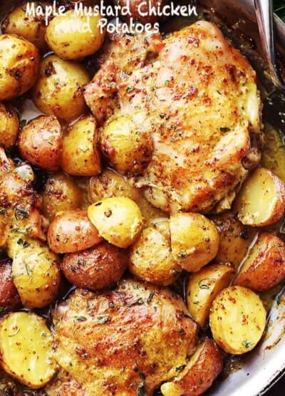 Maple Mustard Chicken and potatoes in a skillet.