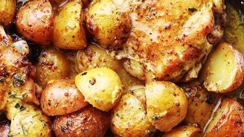Maple Mustard Chicken and potatoes in a skillet.