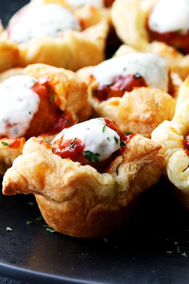 Buffalo Meatballs in Puff Pastry Cups - Delicious buffalo sauce meatballs stuffed inside baked puff pastry cups and topped with blue cheese dressing!