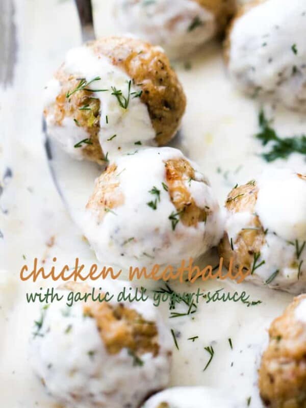 Baked Chicken Meatballs with Garlic Dill Yogurt Sauce - Tender, juicy, perfectly seasoned baked chicken meatballs topped with a delicious garlic and dill yogurt sauce.