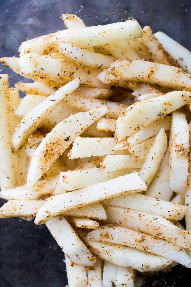 Seasoned raw potatoes cut into fry sticks.