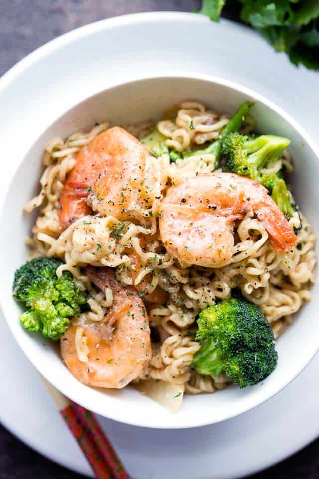 Ramen Noodles served in a white bowl with shrimp and broccoli.