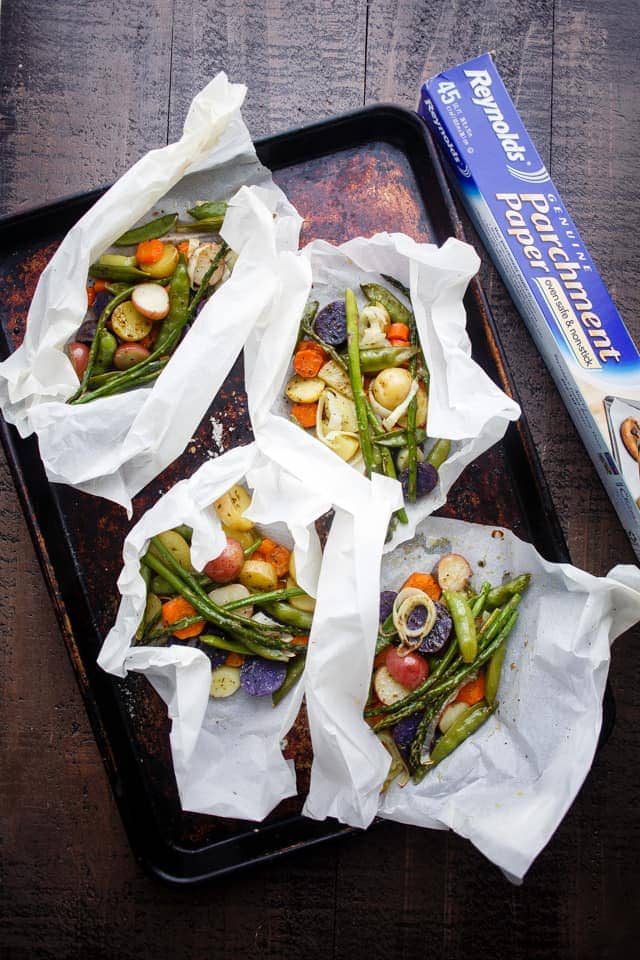 Spring Vegetables and Potatoes Baked in Parchment - Asparagus, snap peas, carrots and potatoes tossed with garlic and olive oil roast up to a deliciously moist and tender perfection inside parchment paper packs. A healthy, fast and real easy must-make-now-side-dish.