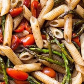 Penne pasta tossed with cooked asparagus and fresh tomatoes.